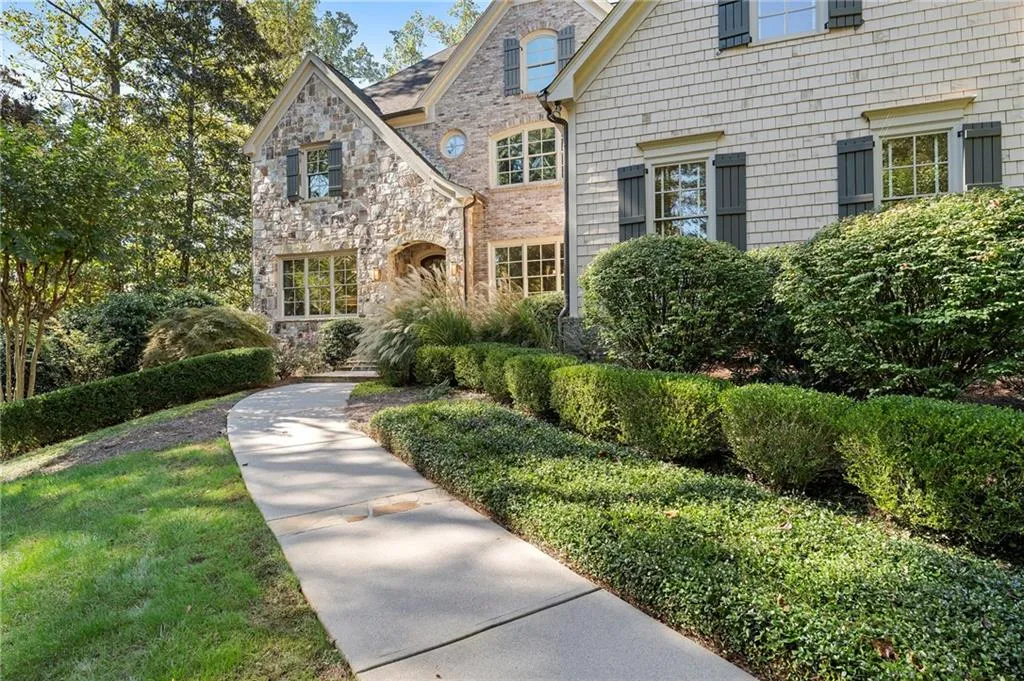 An exquisitely landscaped approach welcomes friends and family.