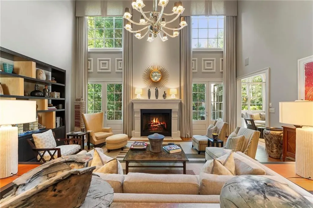 Enter the stunning living room with a dramatic two story window wall and stately fireplace.