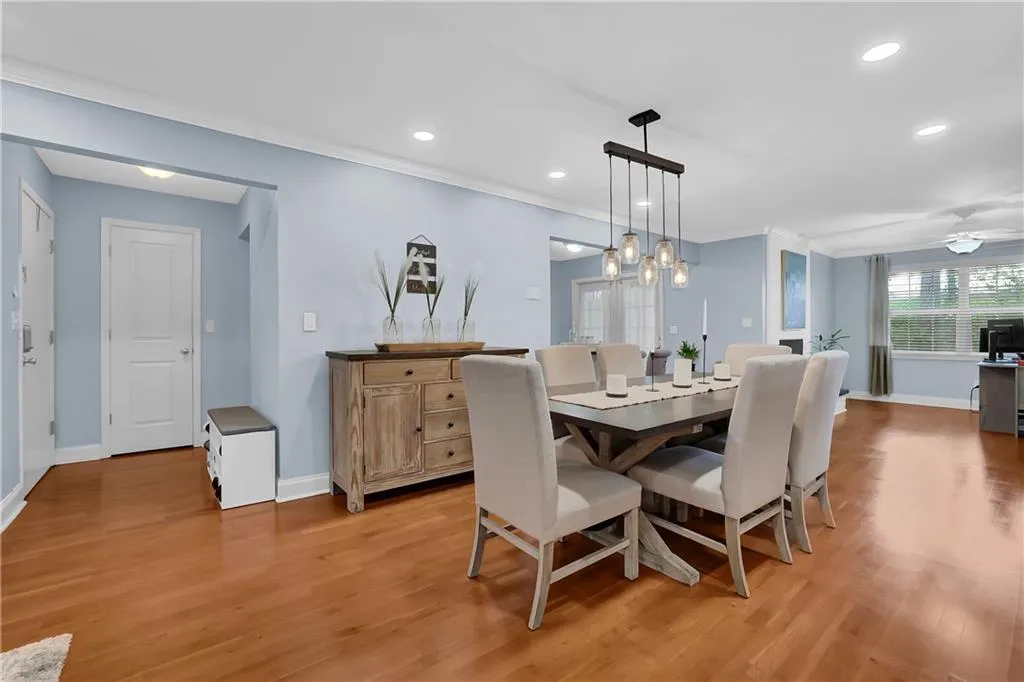 Dining space with crown molding, light hardwood / wood-style floors, and ceiling fan