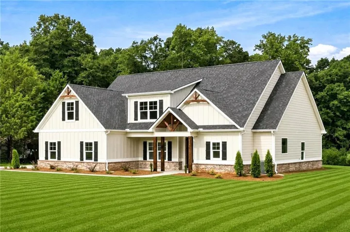 Craftsman-style exterior with mixed siding, stone accents, and a covered entry