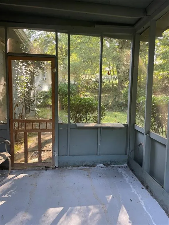 Unfurnished sunroom with plenty of natural light