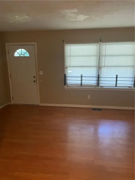 Entrance foyer with healthy amount of natural light and wood finished floors