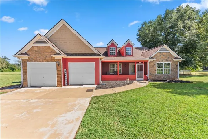 Red exterior with stone accents and two dormer windows