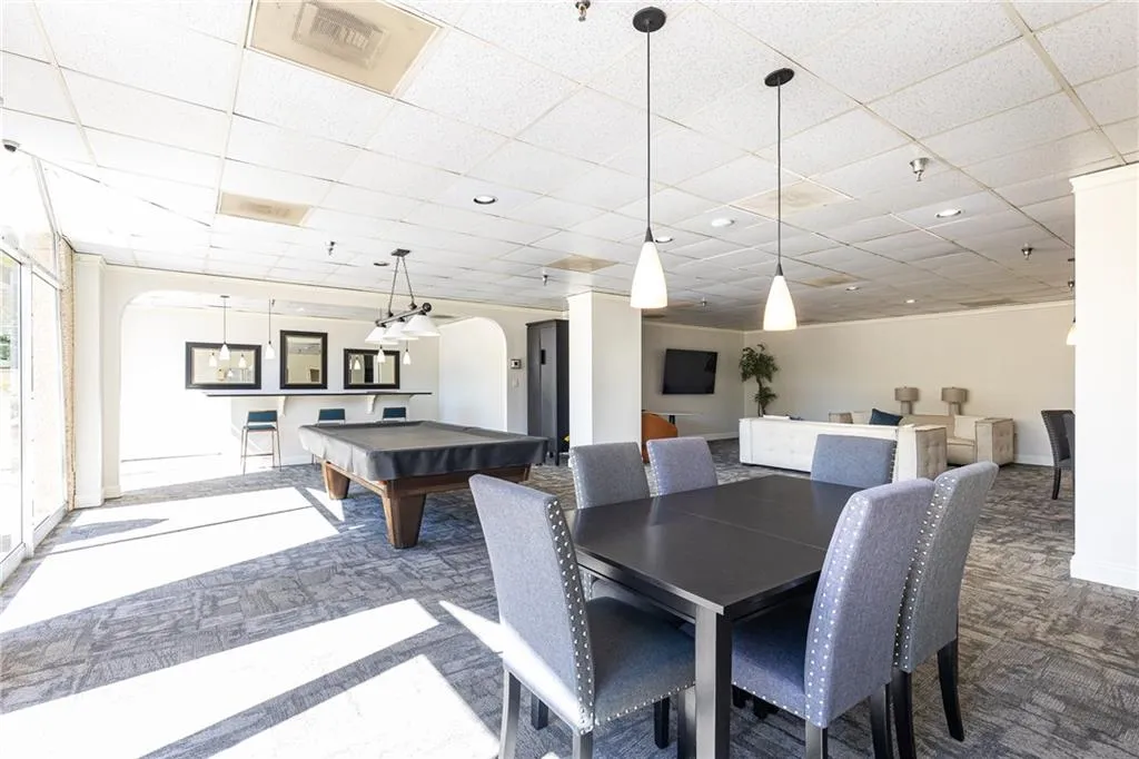 Community gathering space with dining tables and room for entertaining.