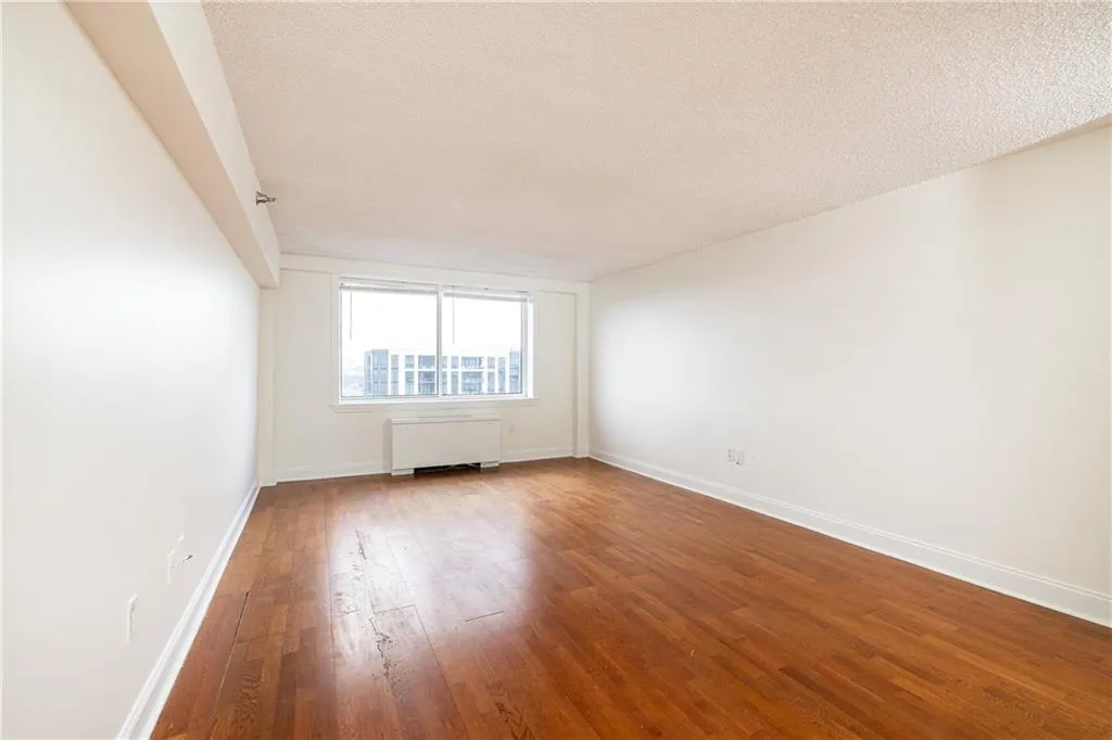 Bright living room with hardwood floors and abundant natural light.