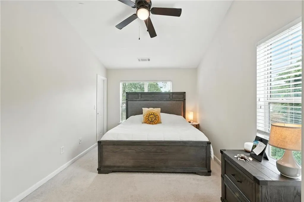 Bedroom featuring light colored carpet and ceiling fan