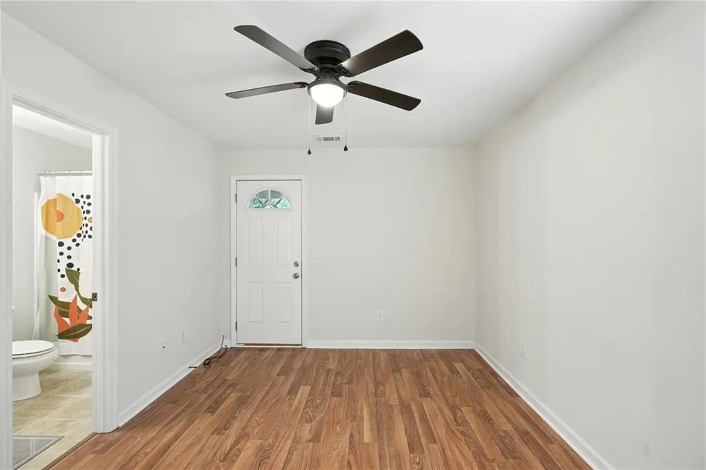 Empty room featuring wood finished floors and ceiling fan