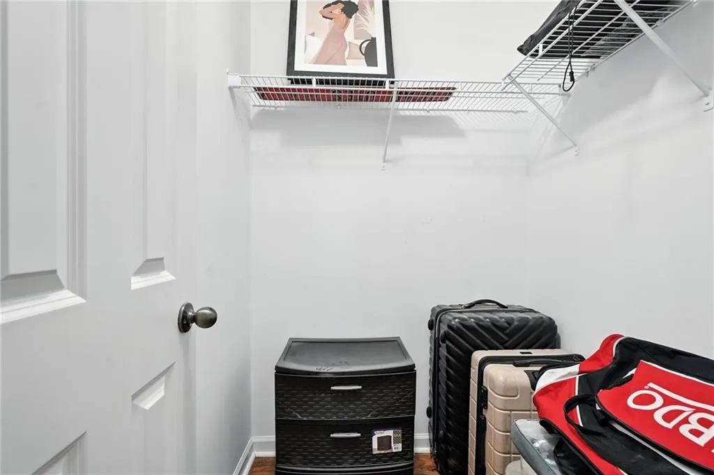 Walk in closet featuring wood finished floors