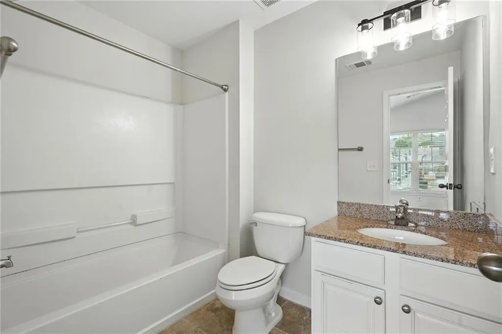 Bathroom featuring vanity and shower / tub combination