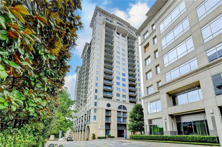 High-rise building featuring multiple balconies and a beige exterior facade