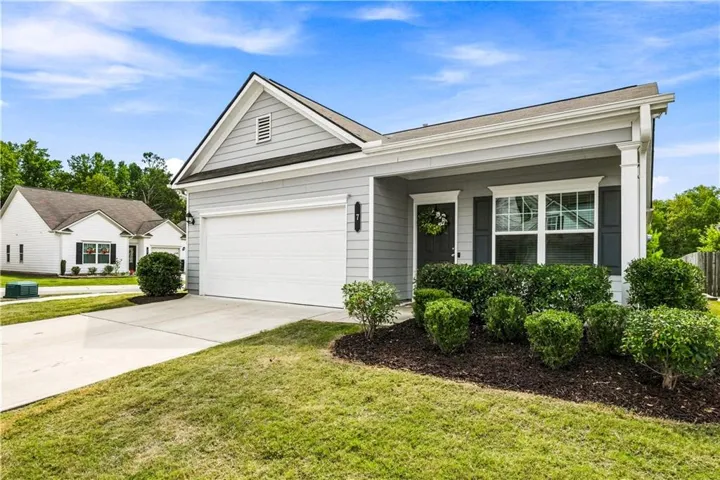 Light gray siding exterior with a single-car garage and concrete driveway