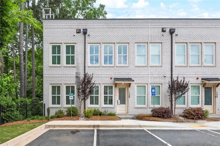 Modern end-unit townhome in Adyn Park featuring stylish white brick exterior, dedicated parking, and a
prime Woodstock location near shopping, dining, parks, and trails.
