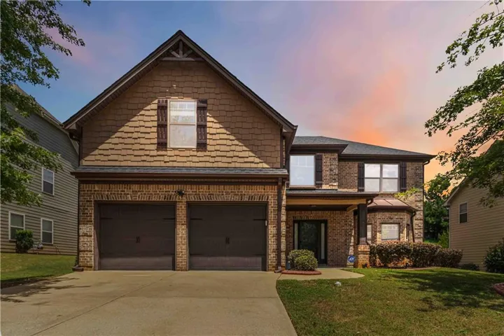Brick and shingle exterior with a two-car garage