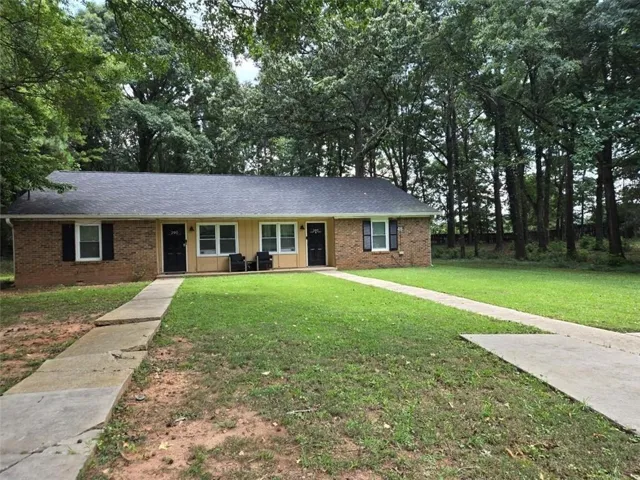 Duplex property featuring brick and siding exterior construction