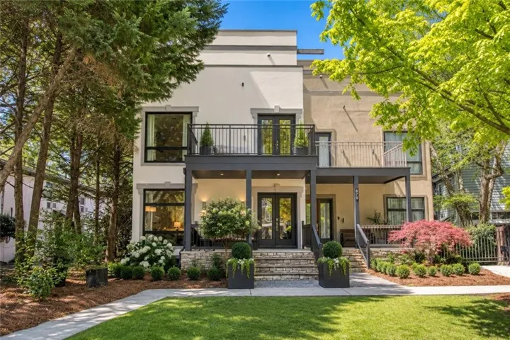866 Monroe Drive NE inspiration photo with creamy white exterior with charcoal accents for a fresh, sophisticated look. Layered landscaping and contemporary details add polished curb appeal.