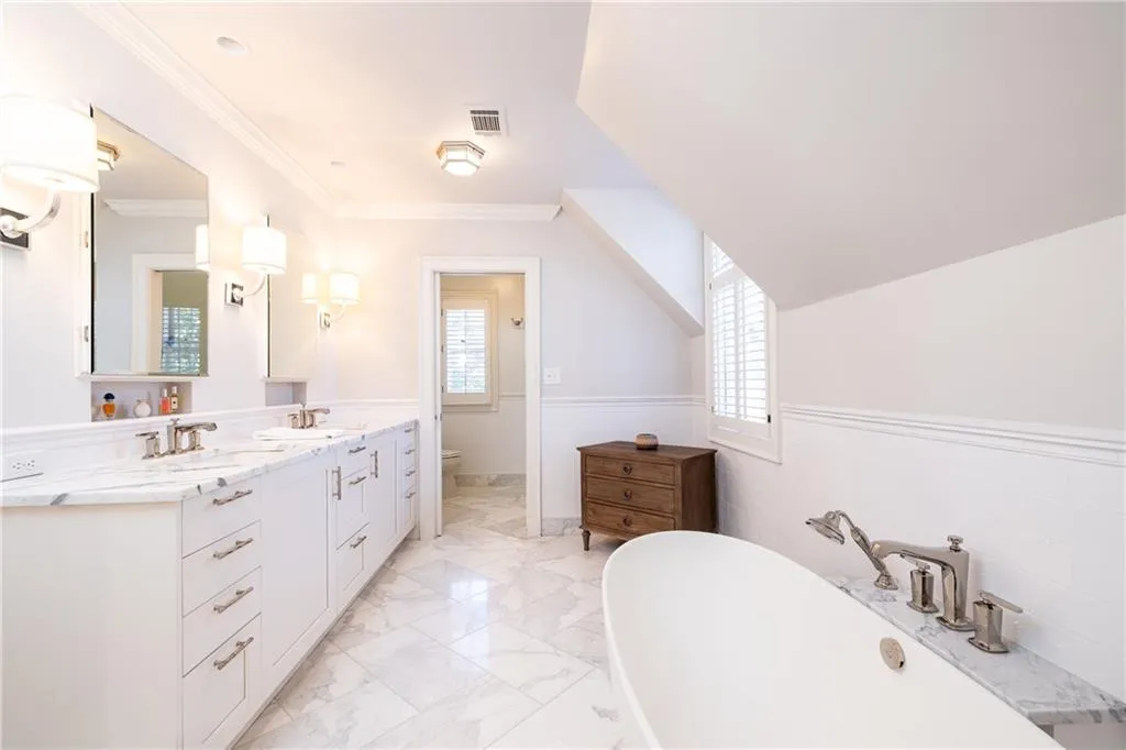 Marble lined primary bathroom