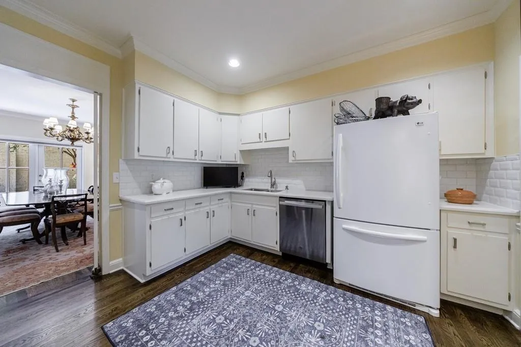 Walls were removed to create a kitchen opening to breakfast area. The solid wood cabinetry was saved and new hardware added. The hardwoods under tile flooring was also saved and refinished.