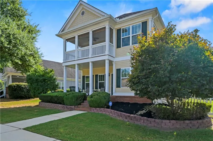 Two-story residence with a screened-in upper balcony and a covered ground-level porch