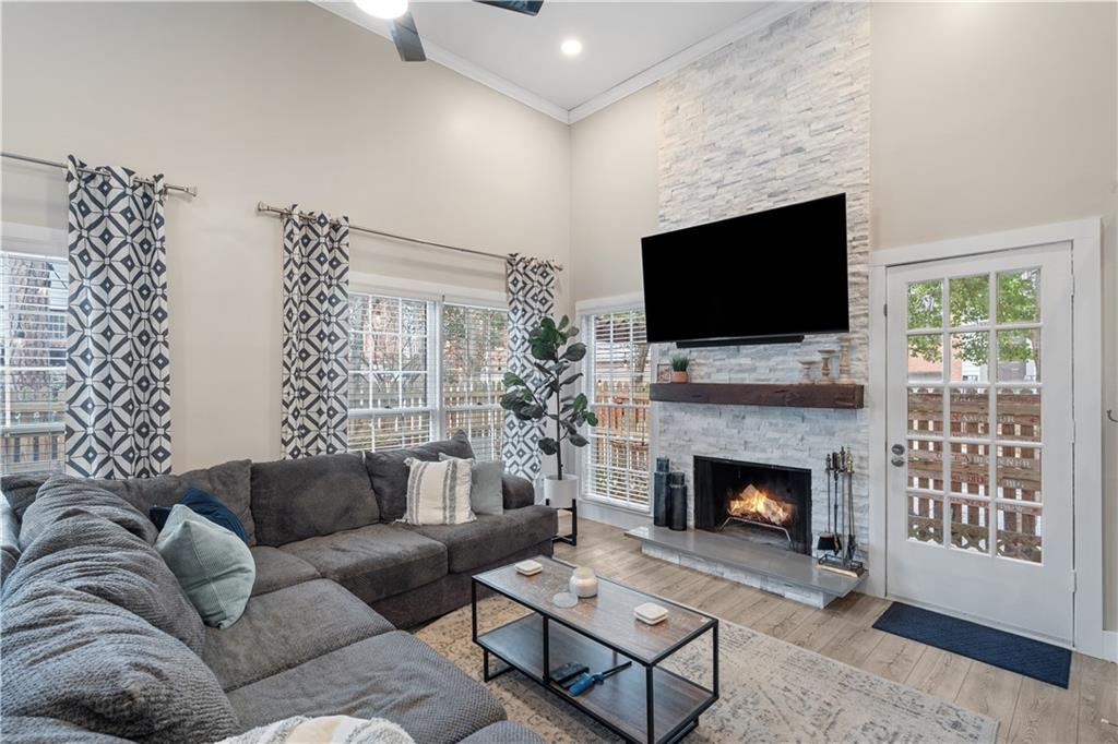 Living room featuring a towering ceiling and fireplace