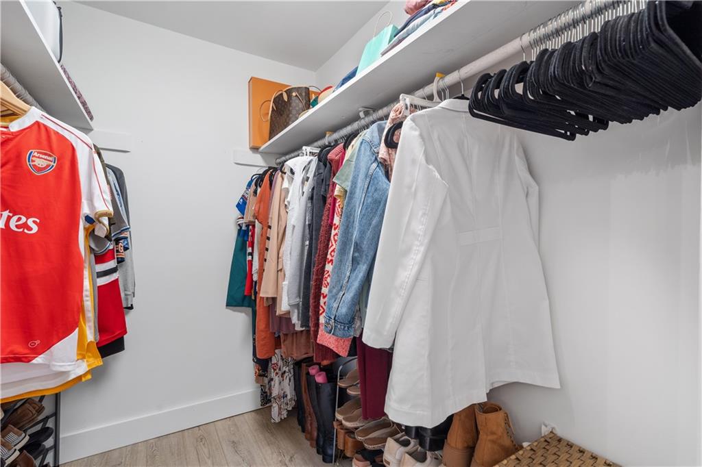Primary bedroom walk in closet