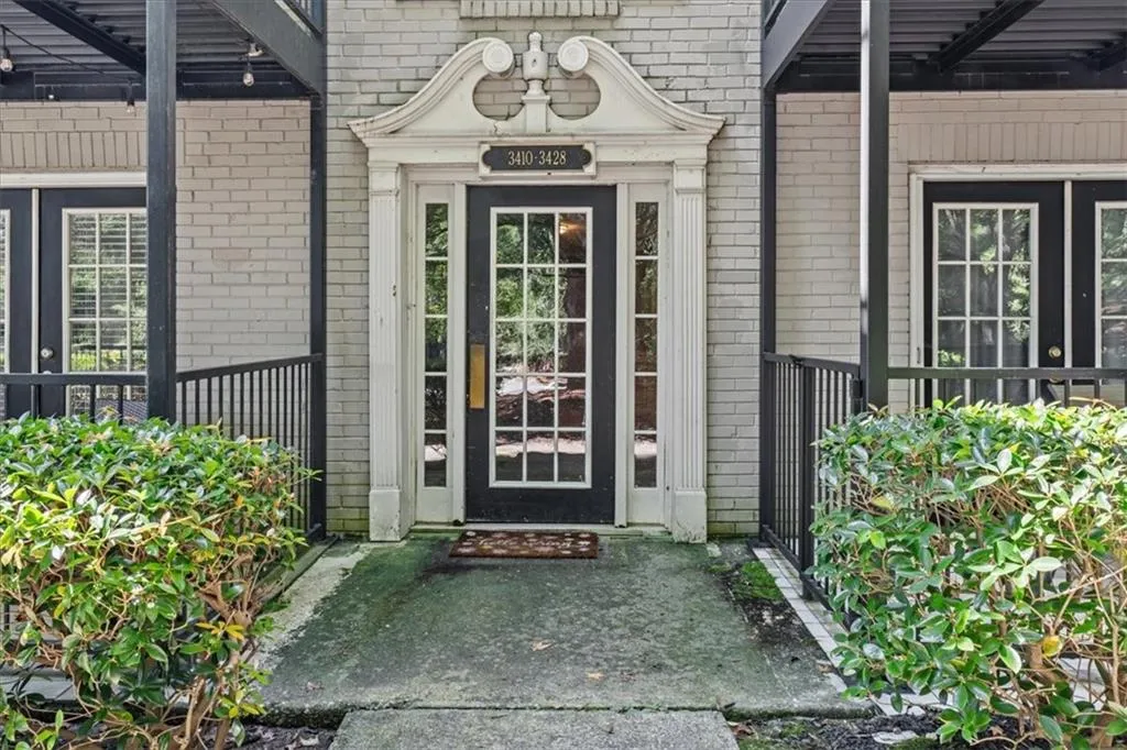 Doorway to property featuring brick siding