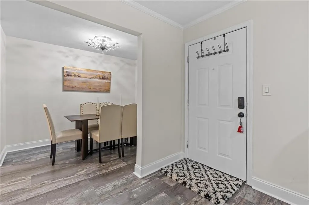 Entrance foyer featuring crown molding and wood finished floors