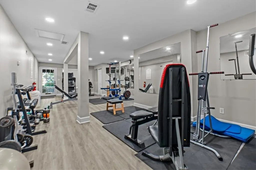 Exercise room featuring recessed lighting and light wood-style floors