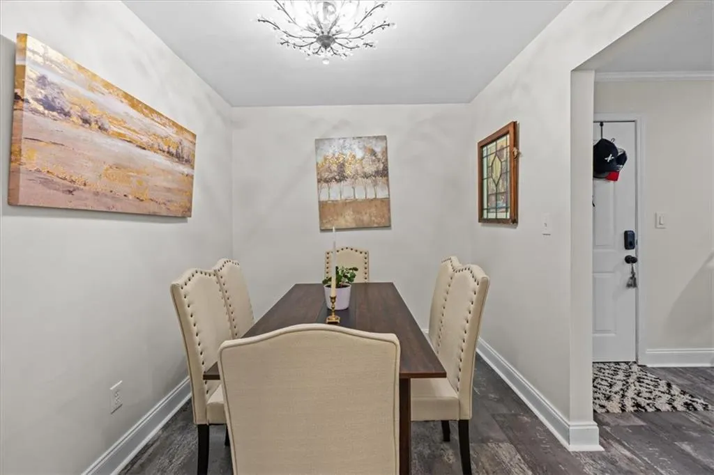 Dining area featuring baseboards and dark wood-style floors