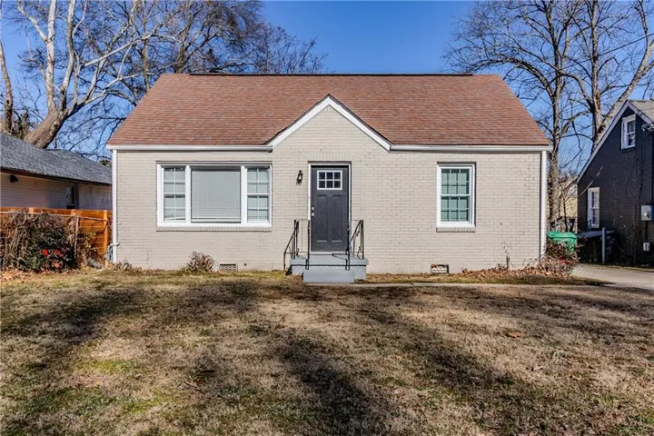 Bungalow-style house with a front lawn