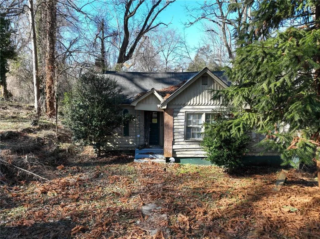 View of front of home featuring a chimney