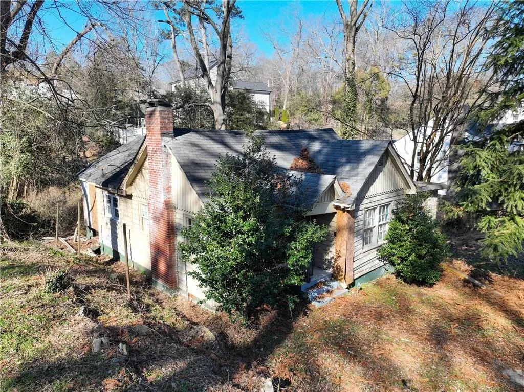 View of side of home featuring a chimney