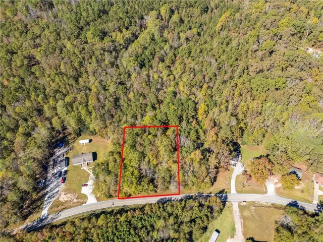 Aerial view of property and surrounding area featuring property parcel outlined