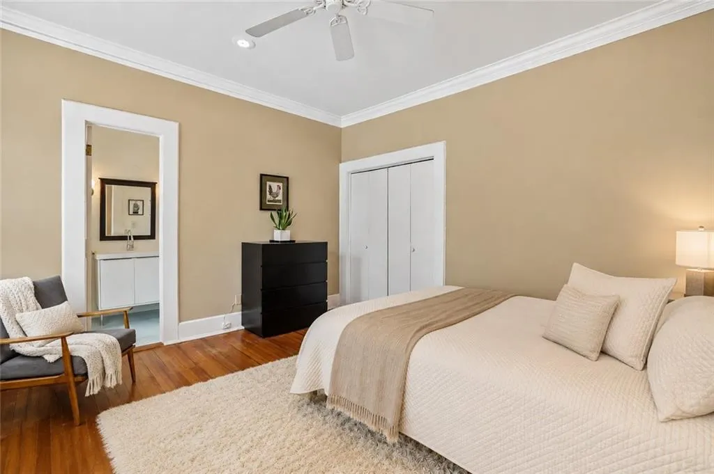 Hardwood flooring, crown molding, ceiling fan, ample closet space, and recessed lighting. Staging digitally edited.