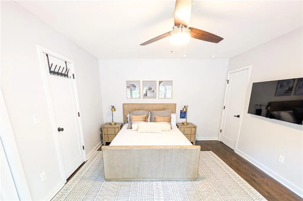 Bedroom with dark wood-style floors and ceiling fan