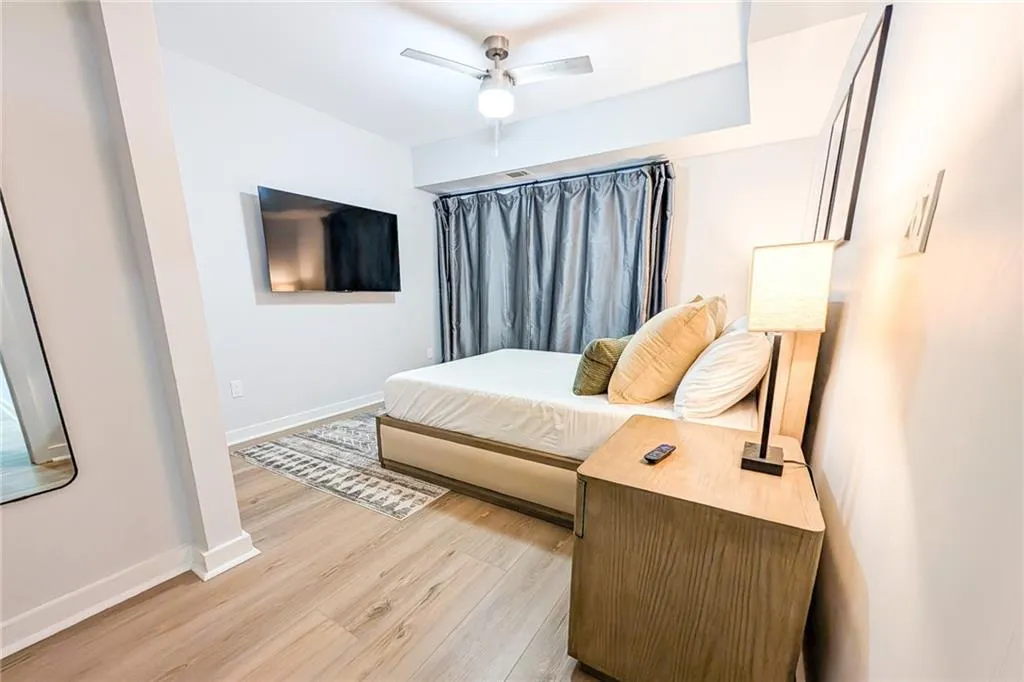 Bedroom with light wood finished floors and a ceiling fan