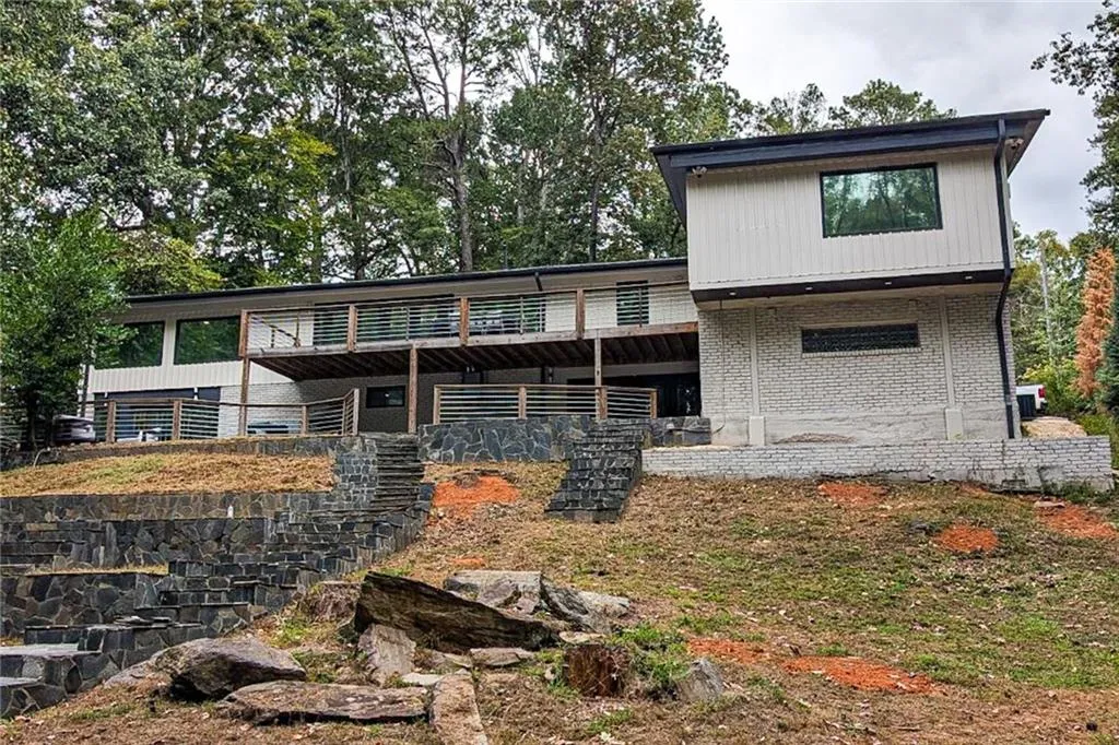 Rear view of property with brick siding