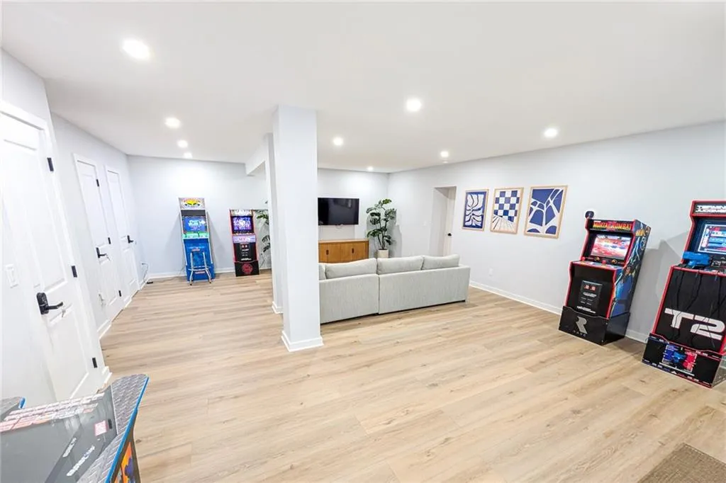 Living room featuring light wood-style flooring and recessed lighting