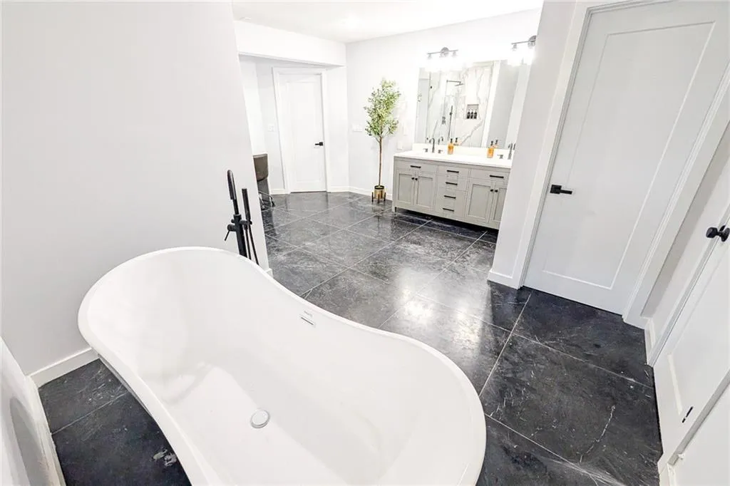 Bathroom with double vanity and a soaking tub