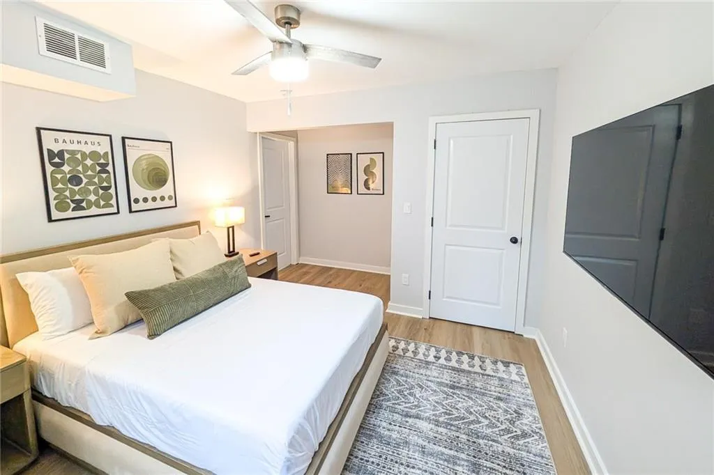 Bedroom with light wood-style floors and ceiling fan
