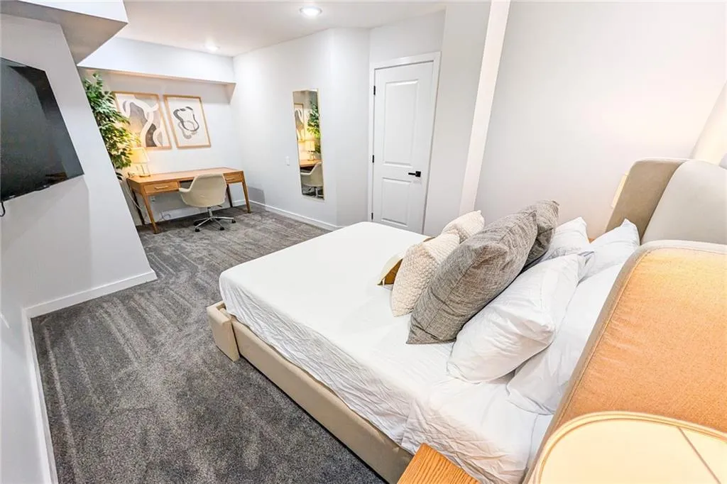 Carpeted bedroom featuring recessed lighting and built in study area
