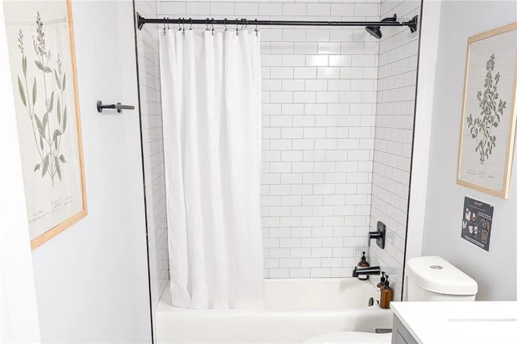 Full bathroom featuring vanity and shower / bath combination with curtain