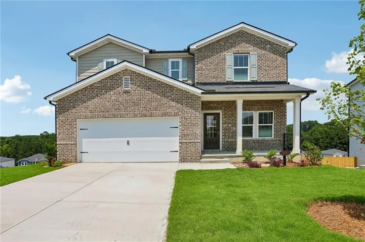 Two-story brick and siding exterior with a covered front porch featuring white columns