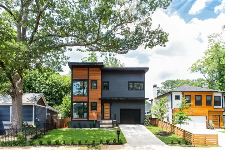Contemporary architectural design featuring dark grey siding and wood-panel accents