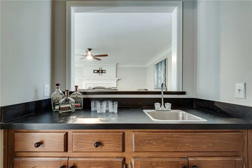 Kitchen with ornamental molding, sink, and ceiling fan