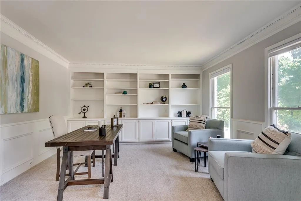 Office space featuring ornamental molding, light carpet, and a wealth of natural light