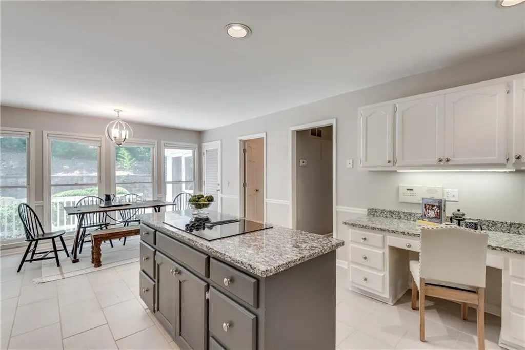 Kitchen with white cabinetry, hanging light fixtures, light tile patterned floors, and gray cabinetry
