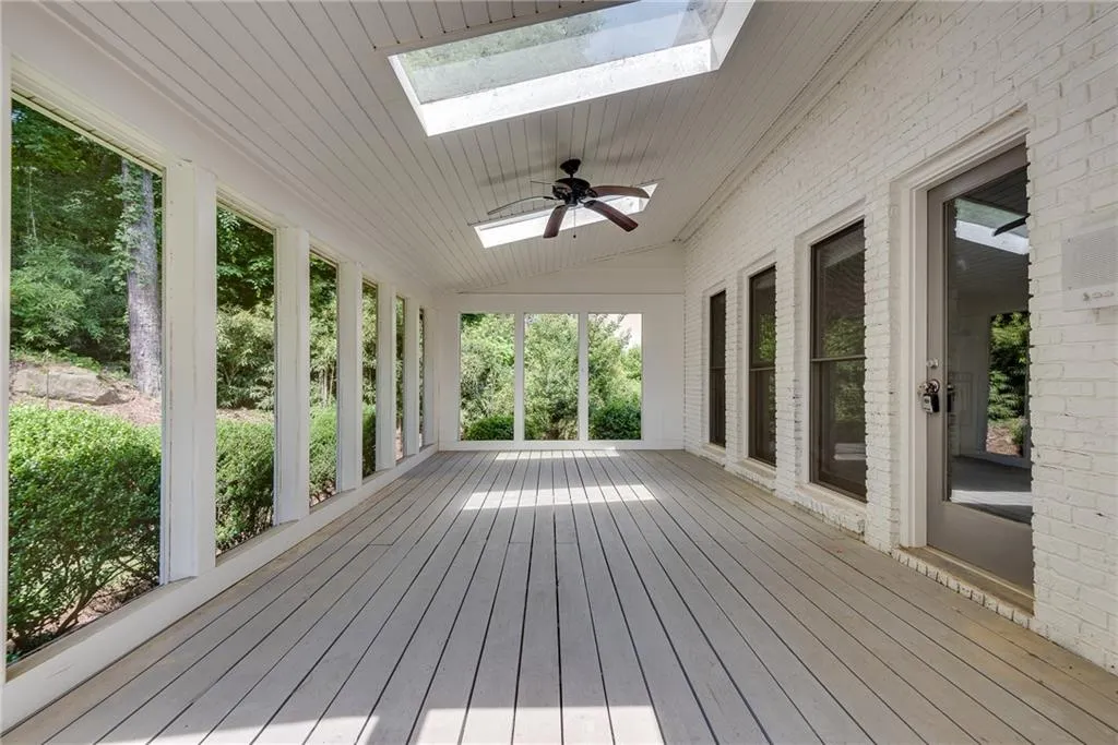 Wooden terrace featuring ceiling fan