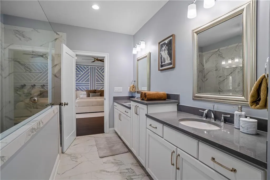 Bathroom with vanity, recessed lighting, ensuite bathroom, a marble finish shower, and marble finish floor