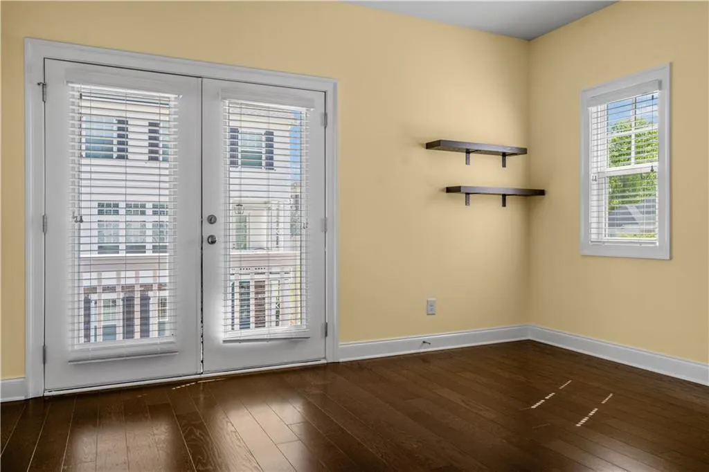 Doorway to outside with baseboards and dark wood-style floors