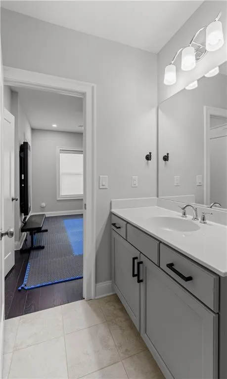 Bathroom with tile patterned flooring, vanity, and baseboards